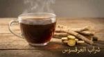 كوب شراب عرقسوس بارد بجانب جذور عرقسوس طبيعية مجففة